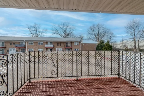 a view of a brick house with wooden fence
