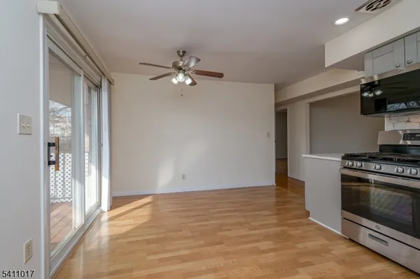 a view of a kitchen with a stove cabinets and a ceiling fan