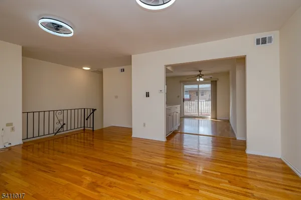 a view of empty room with wooden floor