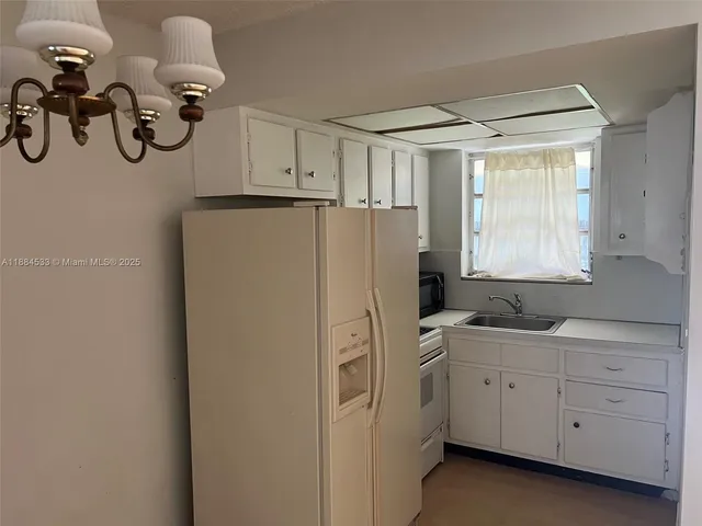a kitchen with a refrigerator and cabinets