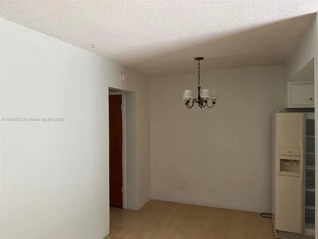 a room with a table and a ceiling fan