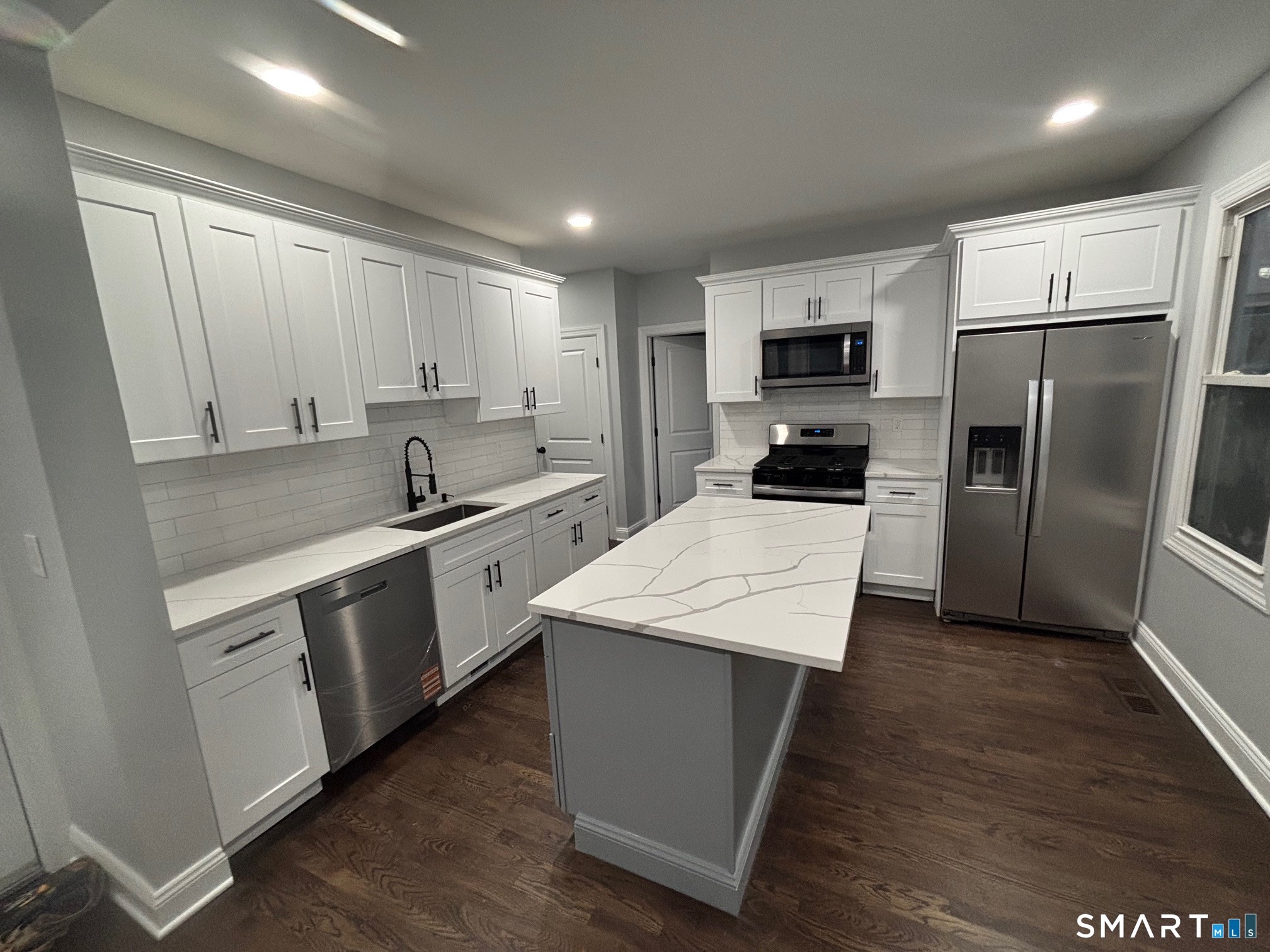 9 Clark Street Ansonia, CT 06401 - Photo 1 of 9 a kitchen with a refrigerator a sink and dishwasher