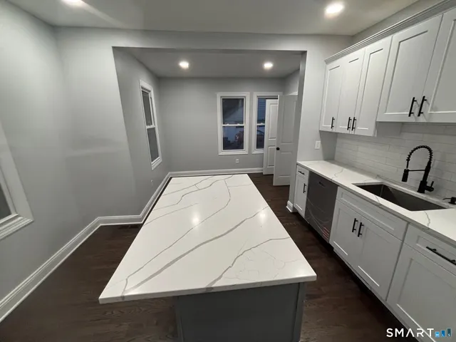 a kitchen with a sink and cabinets