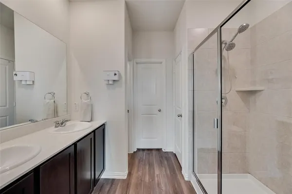 a bathroom with a double vanity sink and mirror