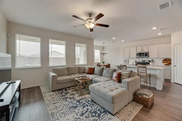 a living room with furniture and kitchen view