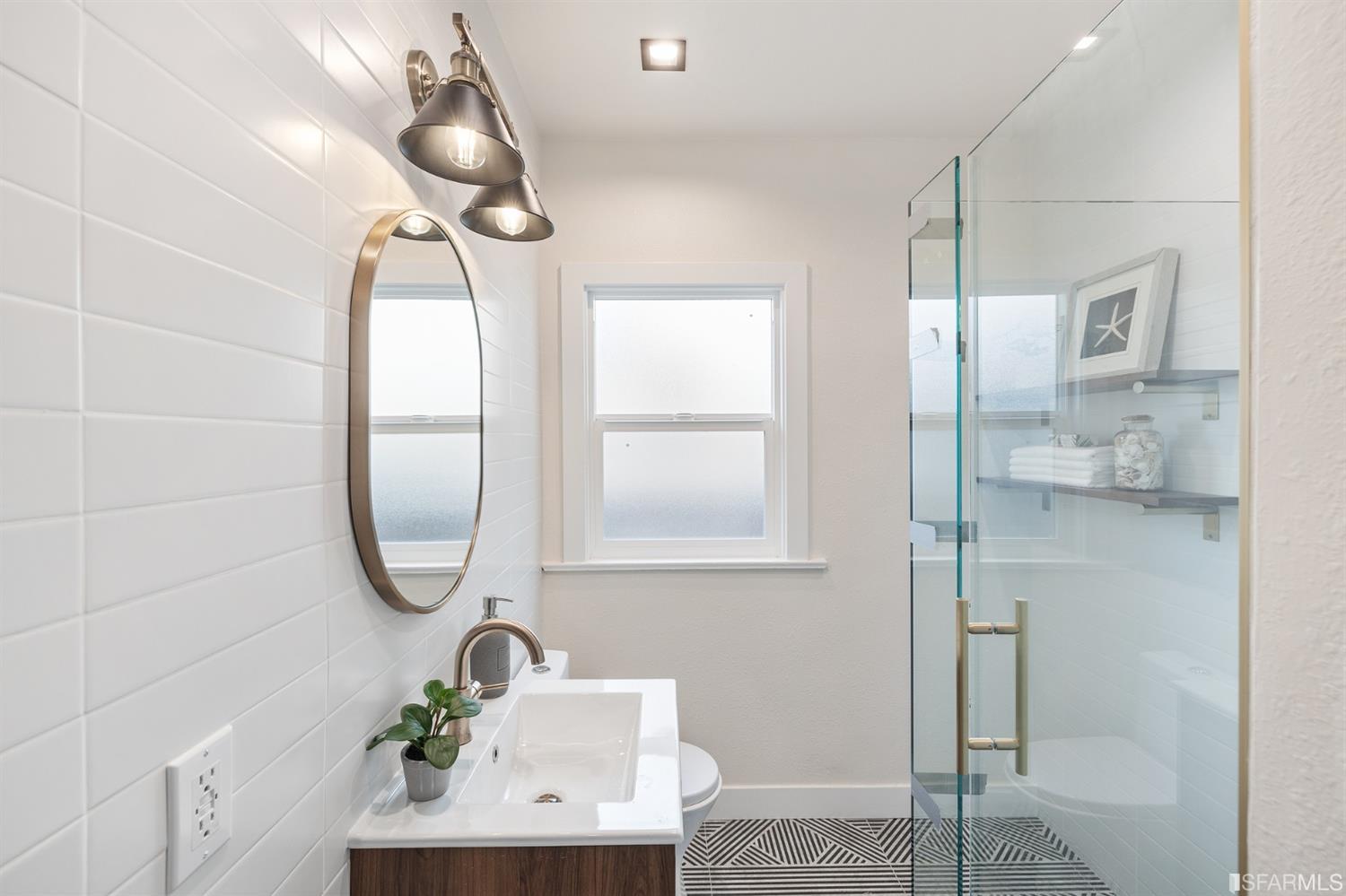 2935 Acton Street Berkeley, CA 94702 - Photo 35 of 63 a bathroom with a sink a mirror and a shower