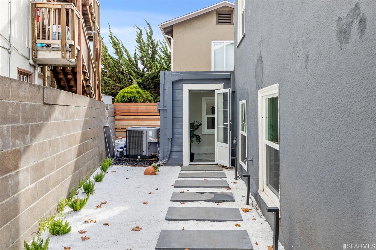2935 Acton Street Berkeley, CA 94702 - Photo 50 of 63 a view of a house with potted plants and a bench in front of door