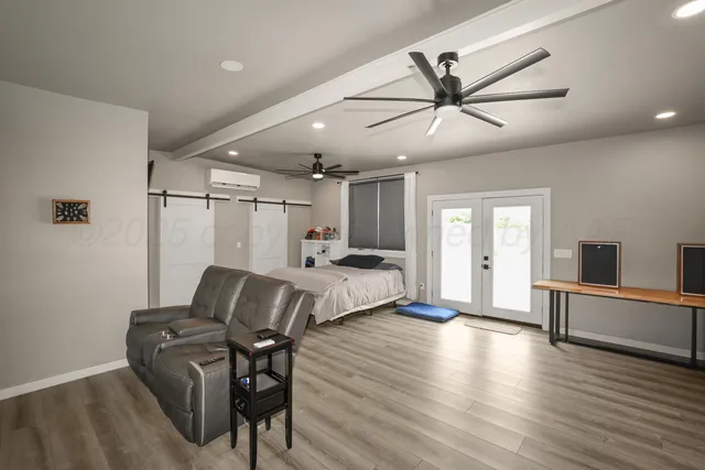 a bedroom with furniture and wooden floor