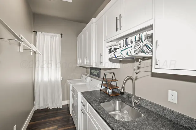 a kitchen with stainless steel appliances granite countertop a sink dishwasher a refrigerator and a stove with wooden floor