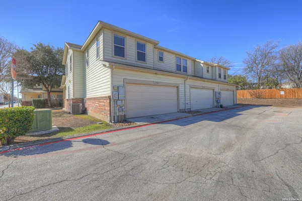 a view of white house with a yard