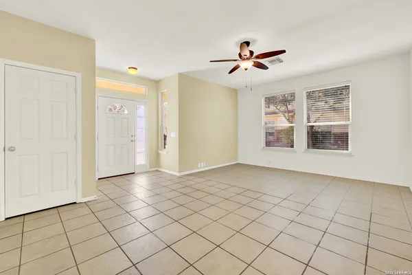 a view of a livingroom with a ceiling fan and window