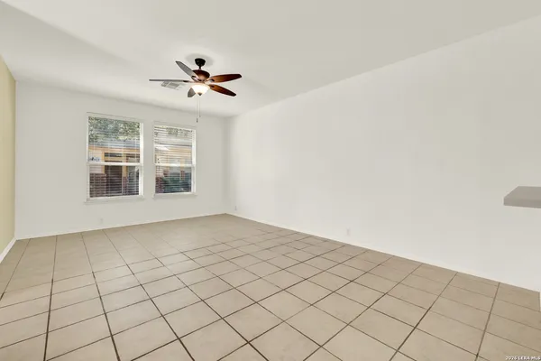 a view of a livingroom with a ceiling fan and window