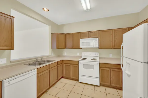a kitchen with a stove sink and refrigerator