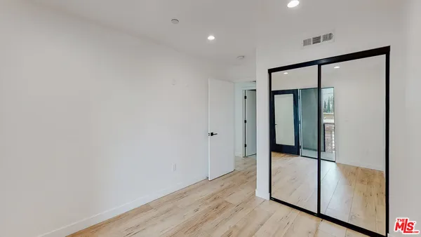 a view of hallway with wooden floor
