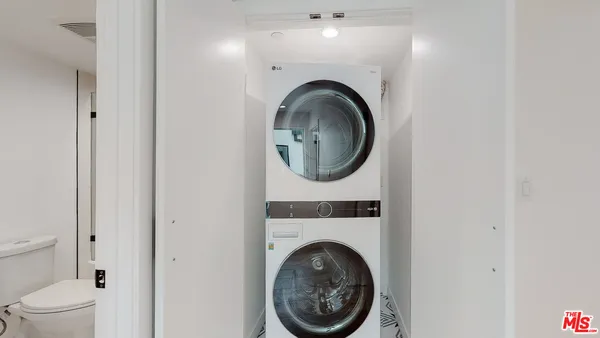 a close view of a bathroom with a washer and dryer