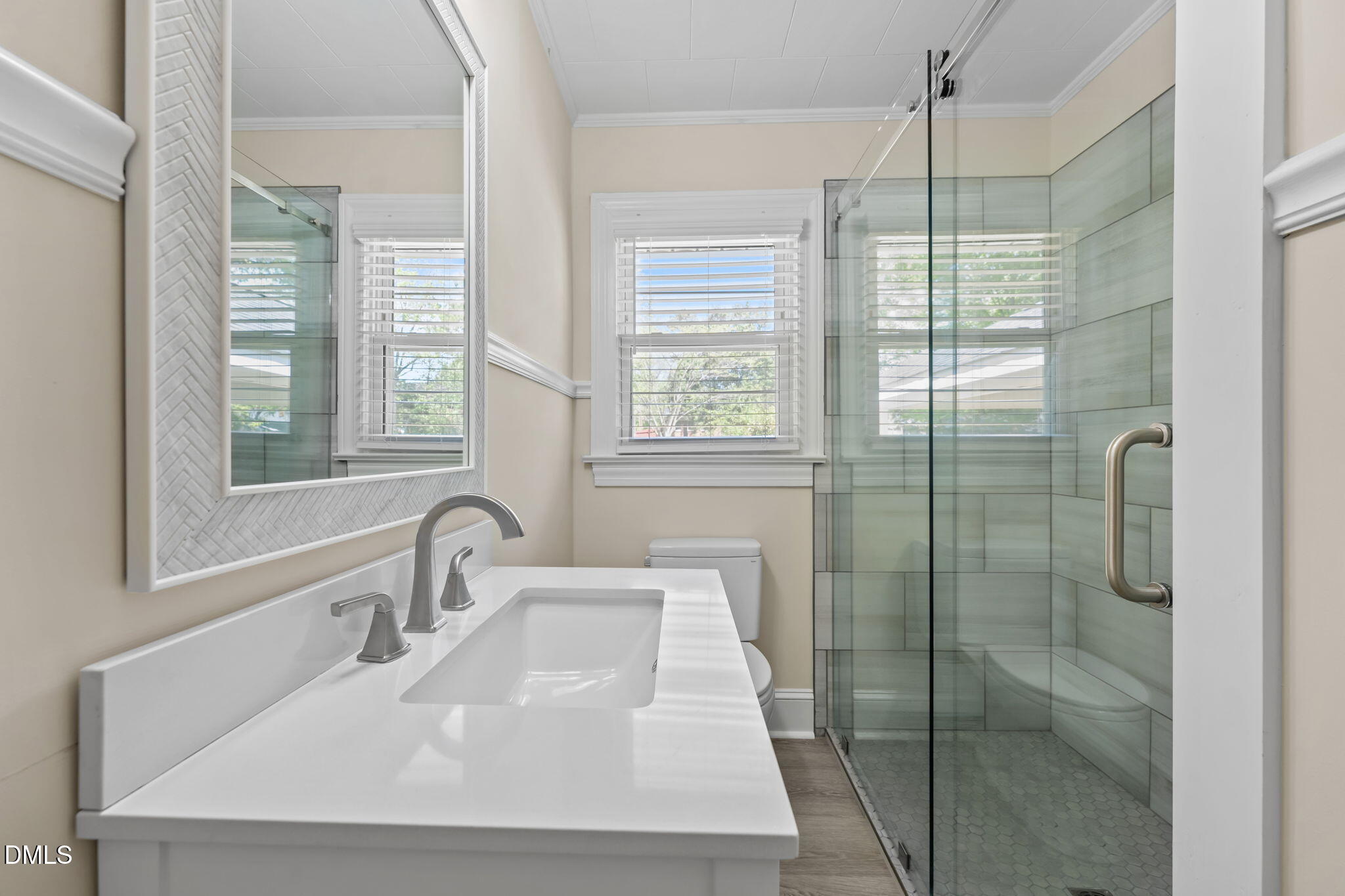 1723 Power Line Road Elon, NC 27244 - Photo 15 of 22 a bathroom with a shower sink and mirror