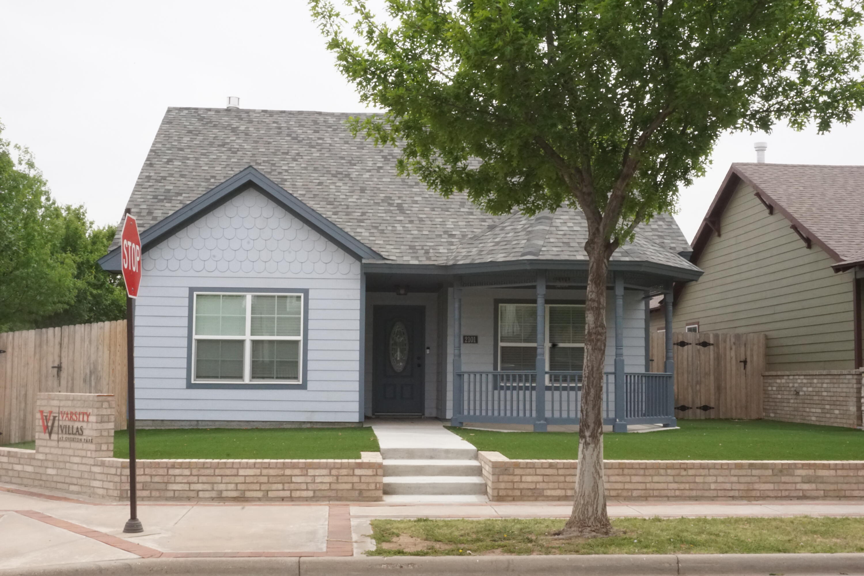 a front view of a house with a garden and plants