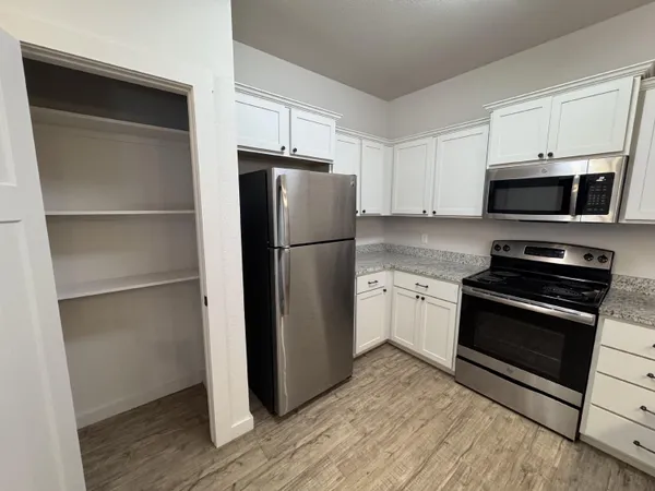 a kitchen with a refrigerator stove and microwave