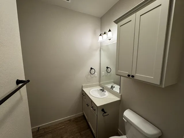 a bathroom with a sink a toilet and mirror