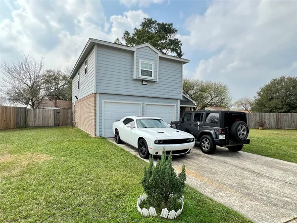 a white house sitting in the middle of a yard