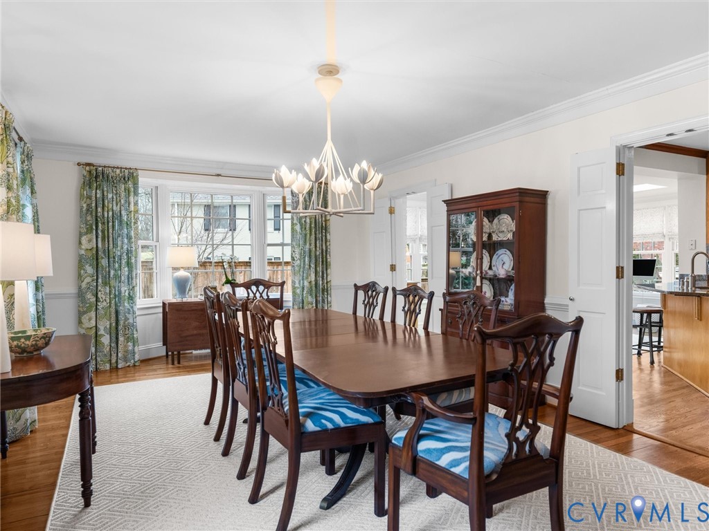 8101 Longwood Road Henrico, VA 23229 - Photo 12 of 49 a dining room with furniture a chandelier and wooden floor