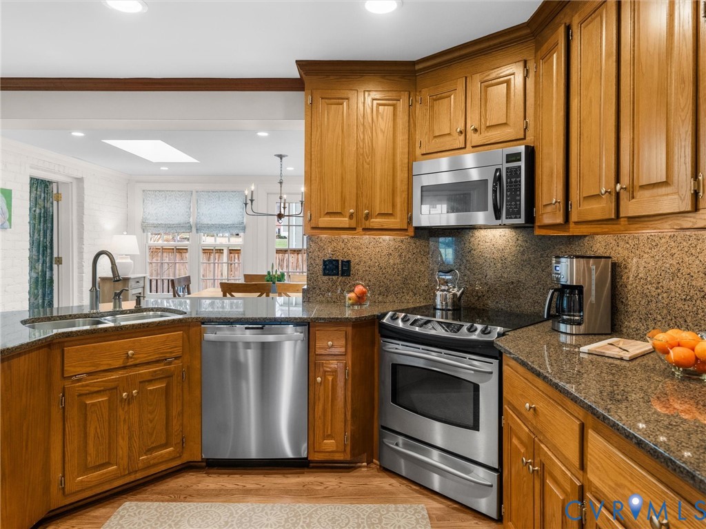 8101 Longwood Road Henrico, VA 23229 - Photo 14 of 49 a kitchen with stainless steel appliances granite countertop a stove a sink and a microwave