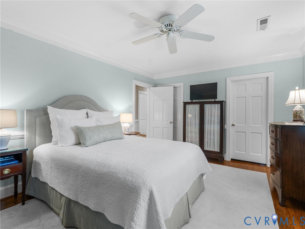 8101 Longwood Road Henrico, VA 23229 - Photo 17 of 49 a bedroom with a bed flat screen tv and a chandelier