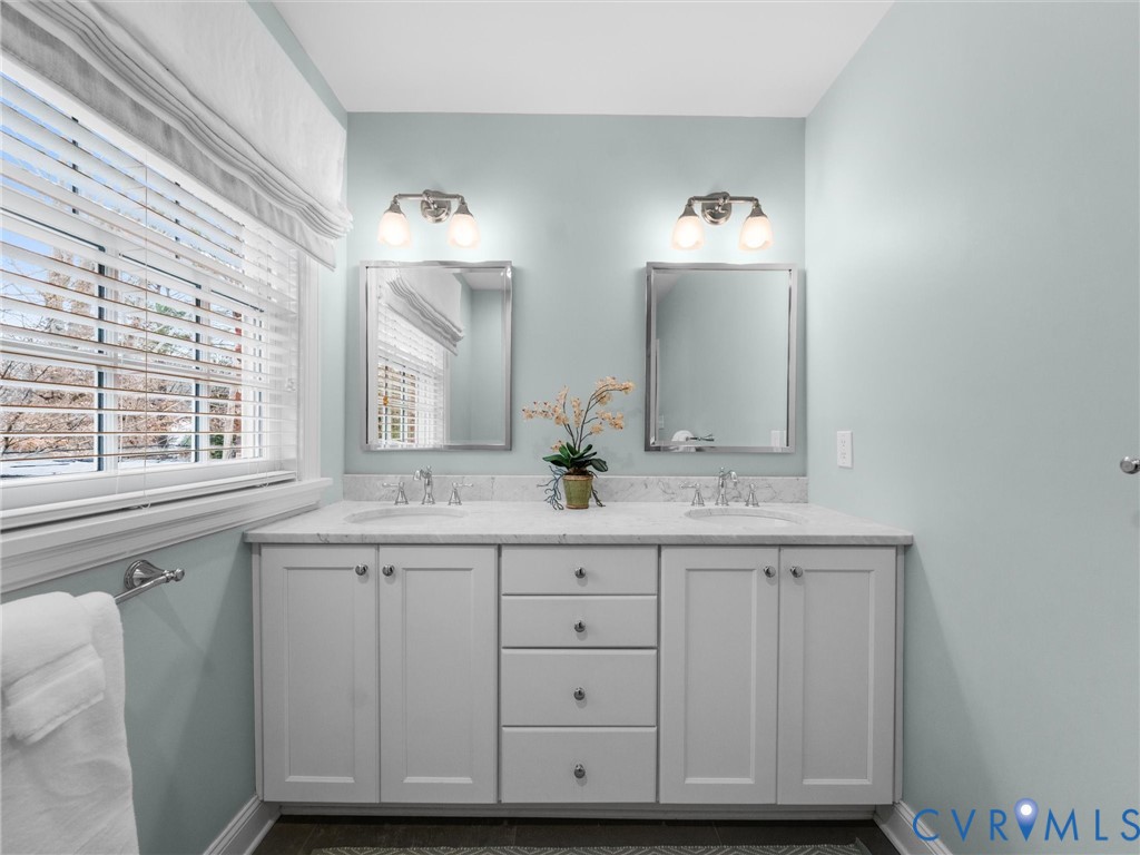 8101 Longwood Road Henrico, VA 23229 - Photo 21 of 49 a bathroom with a sink and two mirror