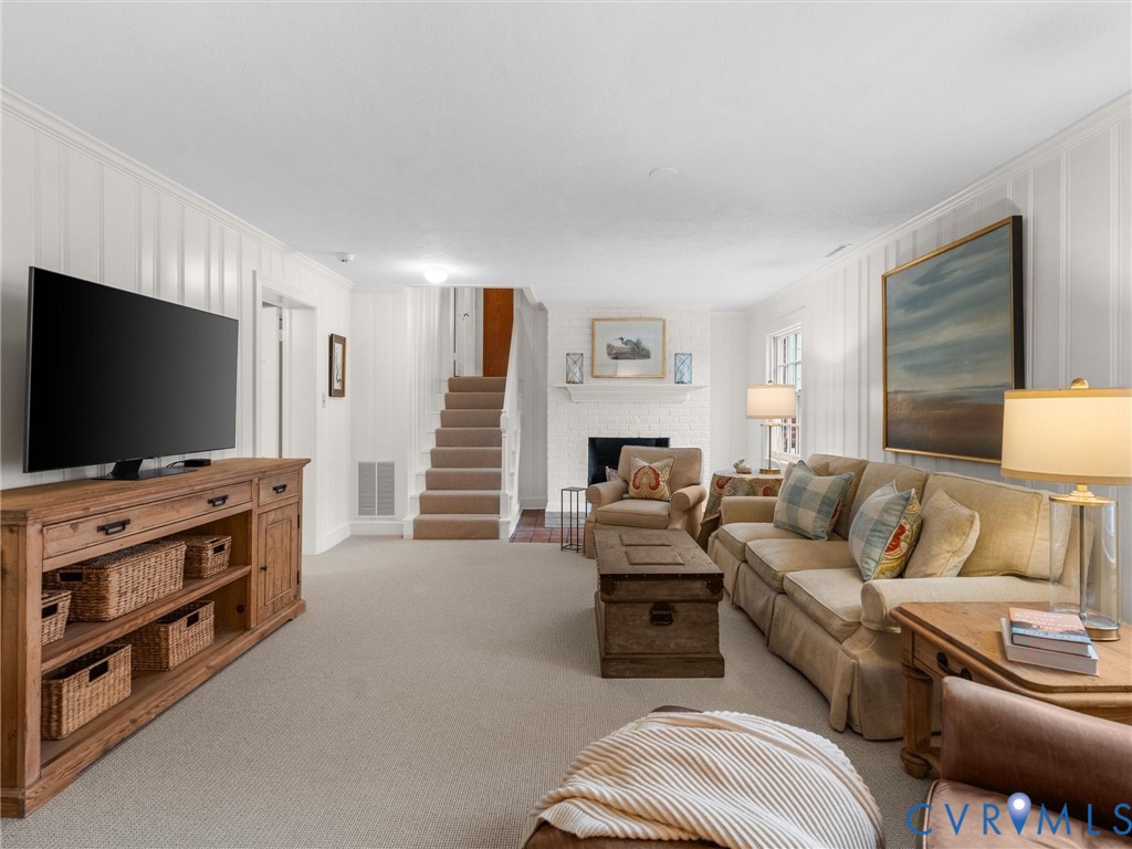 8101 Longwood Road Henrico, VA 23229 - Photo 28 of 49 a living room with furniture and a flat screen tv