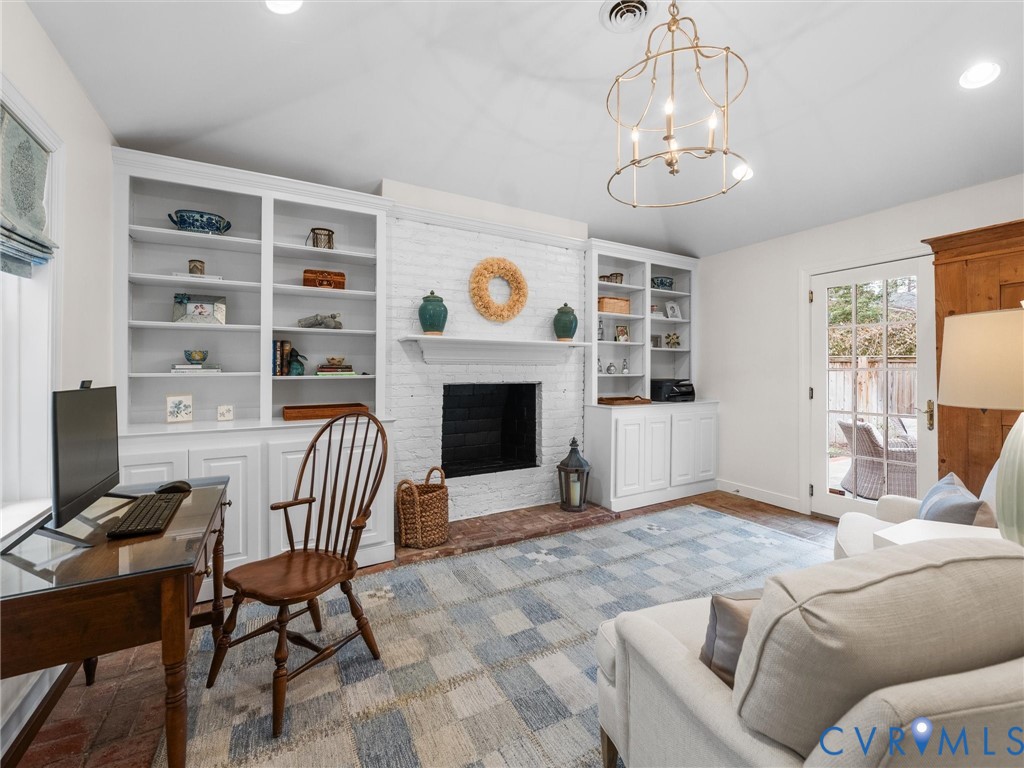 8101 Longwood Road Henrico, VA 23229 - Photo 31 of 49 a living room with furniture a fireplace and a flat screen tv