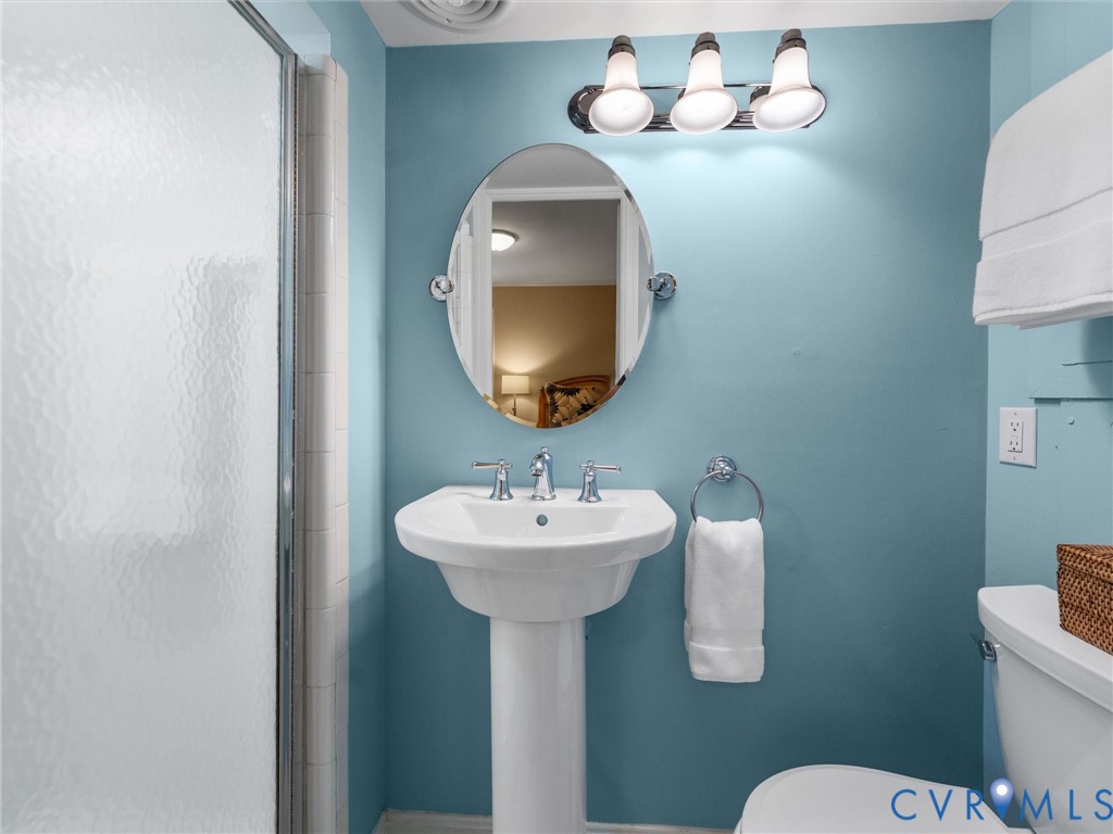 8101 Longwood Road Henrico, VA 23229 - Photo 36 of 49 a bathroom with a sink a mirror and toilet