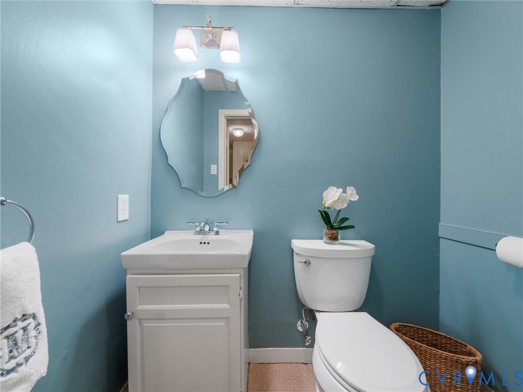 8101 Longwood Road Henrico, VA 23229 - Photo 37 of 49 a bathroom with a toilet sink and mirror