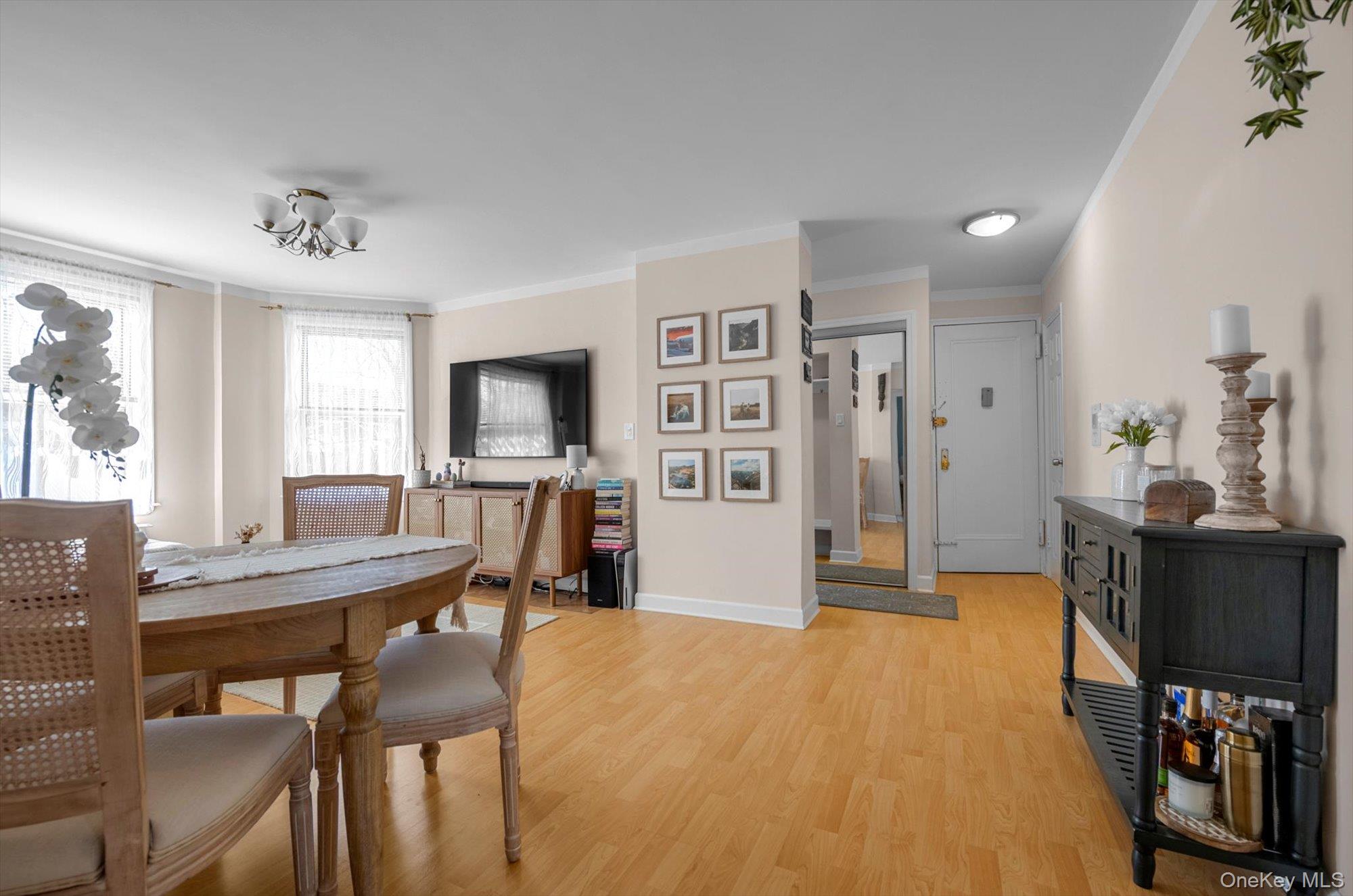 141-45 78th Road, Unit 3A Queens, NY 11367 - Photo 6 of 17 Dining space with light wood finished floors, baseboards, and crown molding
