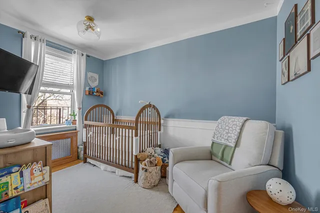 a living room with furniture a flat screen tv and a window