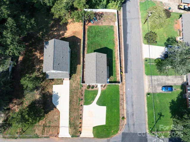 an aerial view of a house with a yard basket ball court and outdoor seating