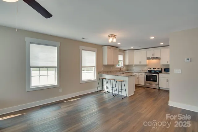 a kitchen with a refrigerator and white cabinets