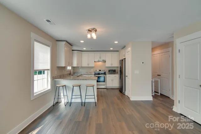 a kitchen with a table and chairs in it