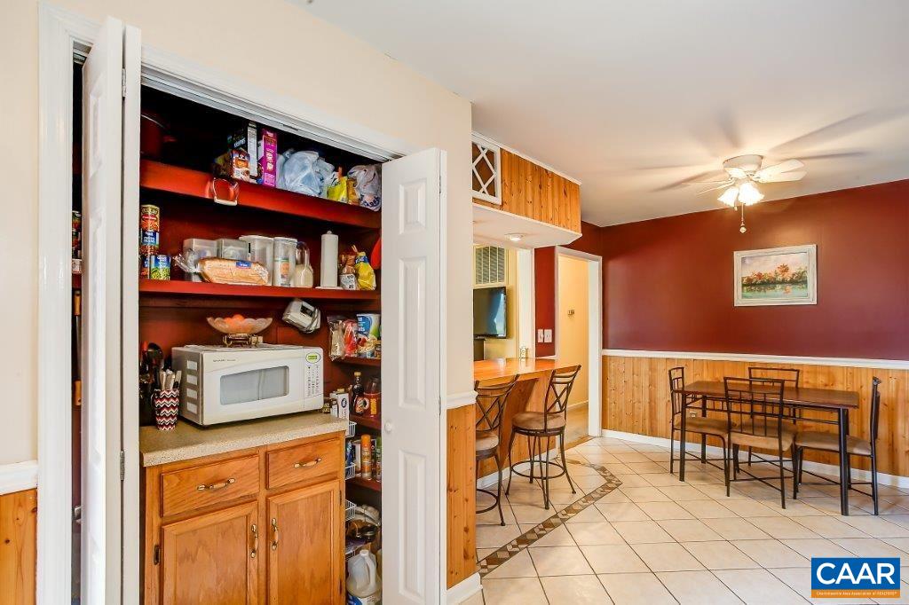 3585 Advance Mills Road Ruckersville, VA 22968 - Photo 25 of 39 a dining room with furniture and a book shelf