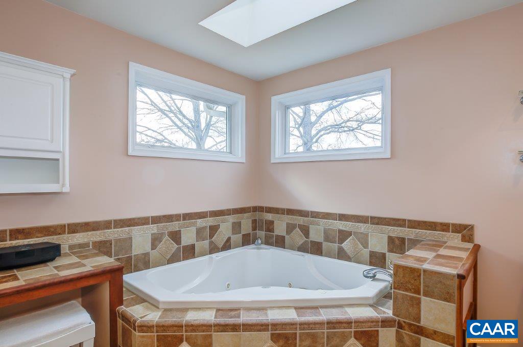 3585 Advance Mills Road Ruckersville, VA 22968 - Photo 32 of 39 a bathroom with a bathtub and next to a window
