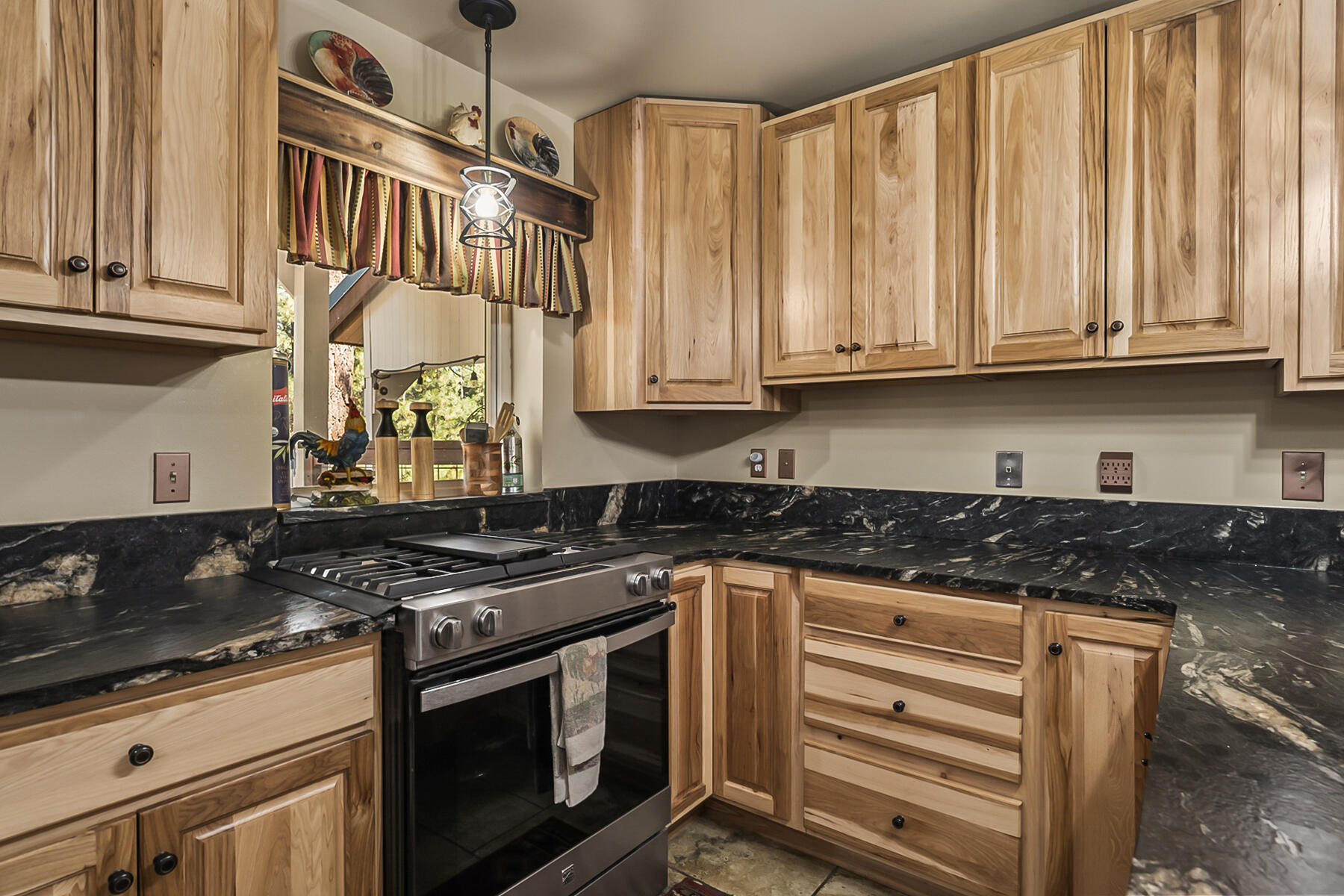 15730 Jackpine Road La Pine, OR 97739 - Photo 15 of 43 a kitchen with granite countertop a stove sink and cabinets