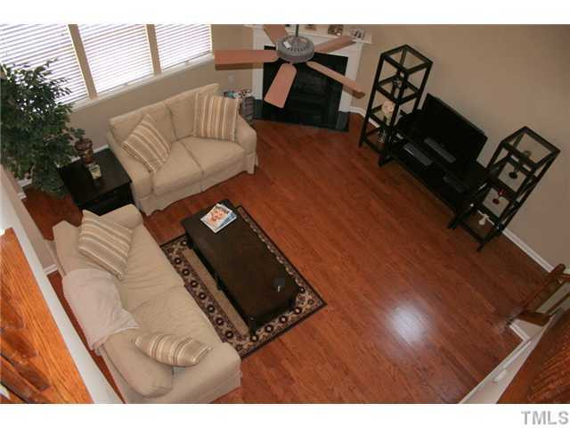 7862 Cape Charles Drive Raleigh, NC 27617 - Photo 2 of 12 a living room with furniture and a wooden floor