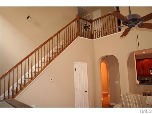 7862 Cape Charles Drive Raleigh, NC 27617 - Photo 4 of 12 a view of staircase with railing and a chandelier