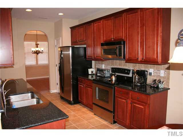 7862 Cape Charles Drive Raleigh, NC 27617 - Photo 5 of 12 a kitchen with stainless steel appliances granite countertop a refrigerator stove top oven