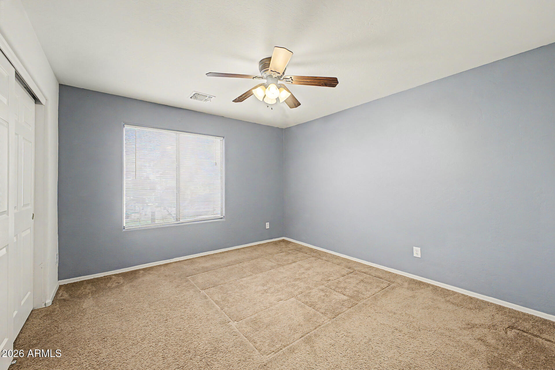 6622 West Harwell Road Laveen, AZ 85339 - Photo 22 of 32 an empty room with windows and fan