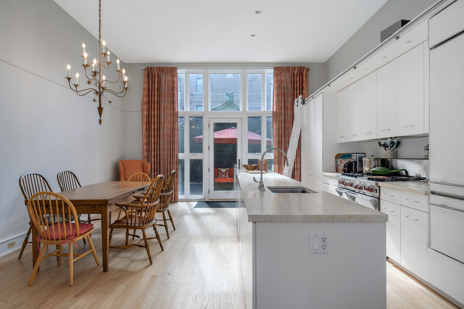2214 North Burling Street Chicago, IL 60614 - Photo 9 of 29 a kitchen with stainless steel appliances granite countertop a table chairs stove and refrigerator