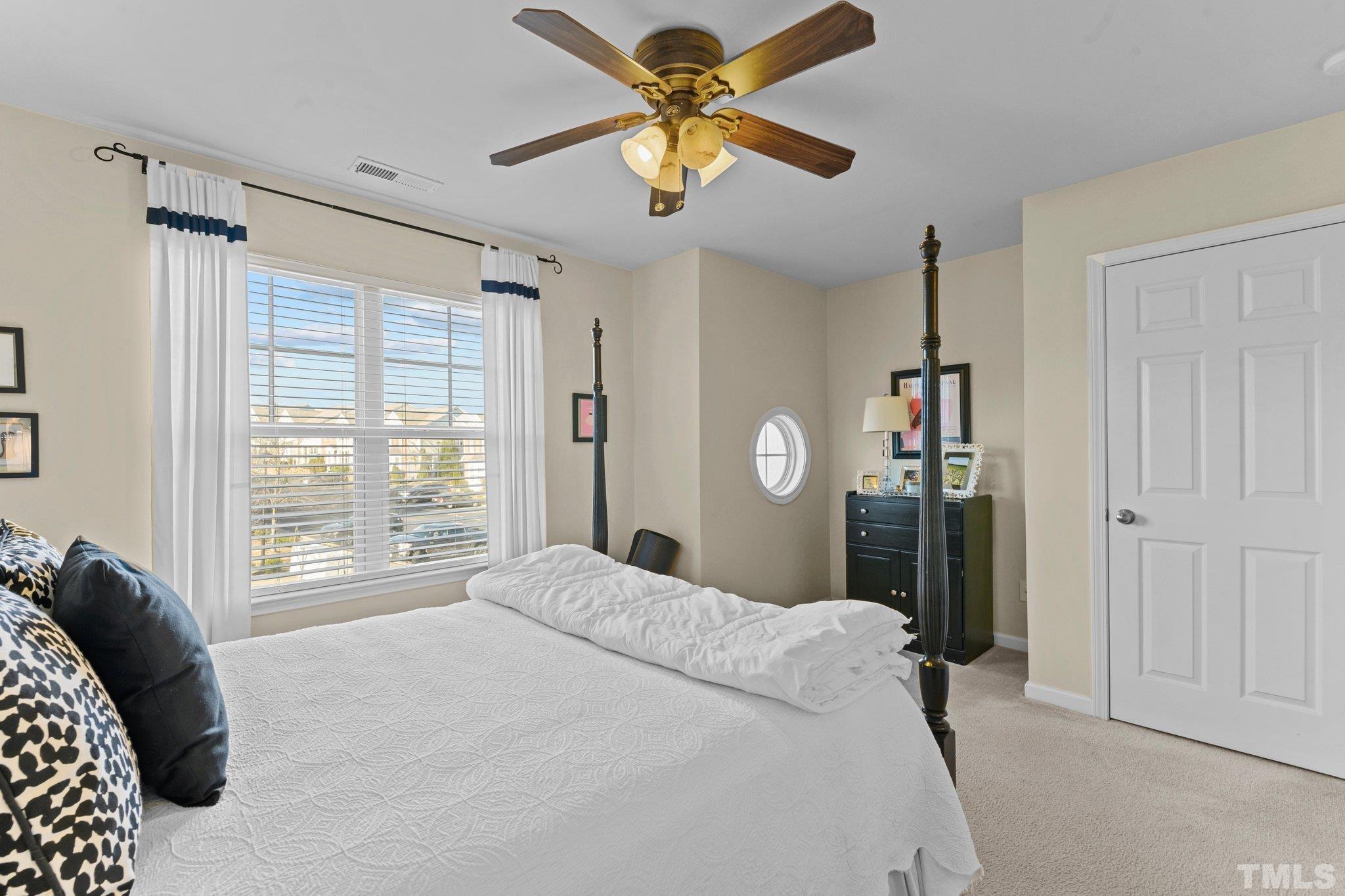 2842 Casona Way Raleigh, NC 27616 - Photo 19 of 27 a bedroom with a bed dresser and a window