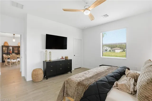 a bedroom with a bed and a flat screen tv