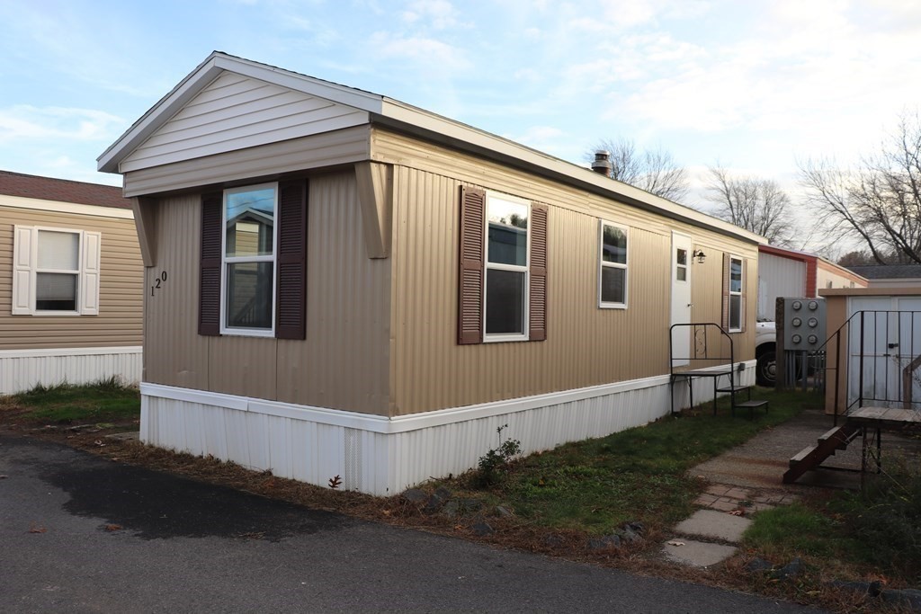 557 Southwest Cutoff, Unit 120 Worcester, MA 01607 - Photo 3 of 17 a front view of a house with a yard