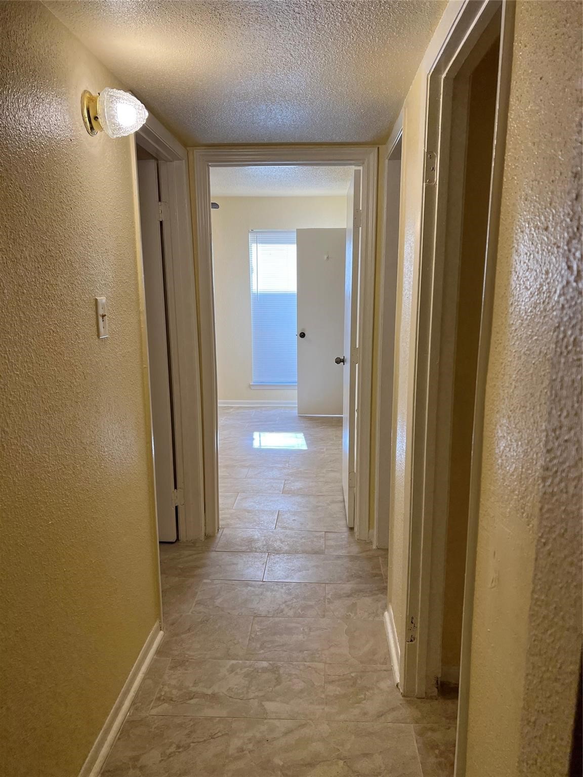 9000 Bissonnet Street, Unit 705 Houston, TX 77074 - Photo 13 of 18 a view of a bathroom from a hallway