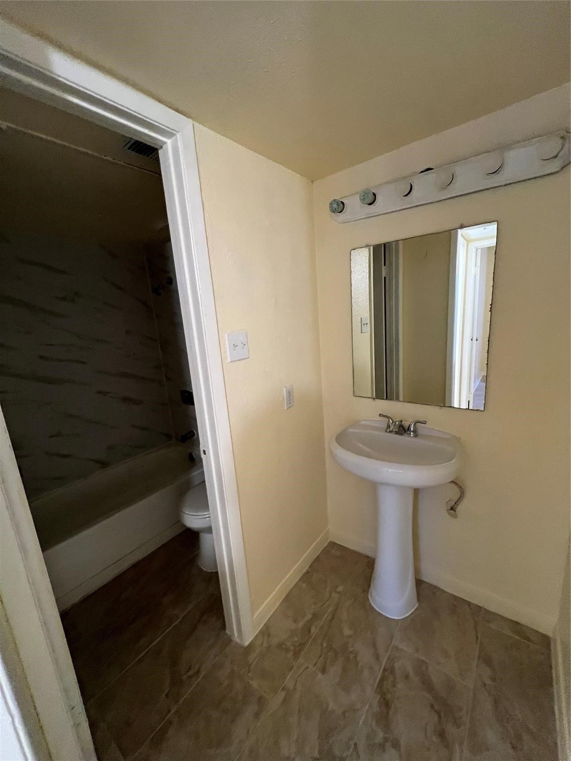 9000 Bissonnet Street, Unit 705 Houston, TX 77074 - Photo 15 of 18 a bathroom with a sink a mirror and a toilet